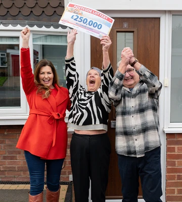 CHEQUE IT OUT: Judie celebrates with Bev and Andy