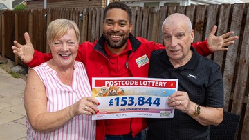 MAY THE FOURS BE WITH YOU: Geraldine and hubby Paul with lottery presenter Danyl Johnson