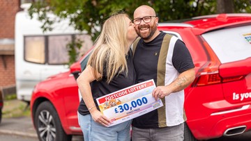 THIRTY THOUSAND SMACKERS: Mark gets a kiss from Michaela after receiving his cheque