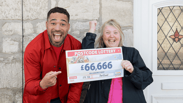 Our winner Jane celebrates winning £66,666 with Danyl