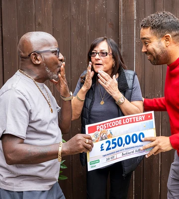 Tony and Tracey get the first of two cheques from Danyl Johnson.