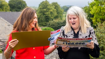 Catherine can't believe her luck as Judie delivers her winner cheques