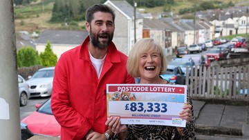 CHEQUE THIS OUT: Michaela shows off her winning sum to her ecstatic family