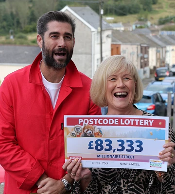 CHEQUE THIS OUT: Michaela shows off her winning sum to her ecstatic family