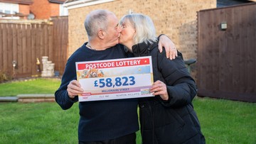 LUCKY IN LOVE: David and Pat Coglan seal their win with a kiss