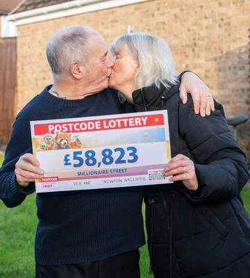 LUCKY IN LOVE: David and Pat Coglan seal their win with a kiss