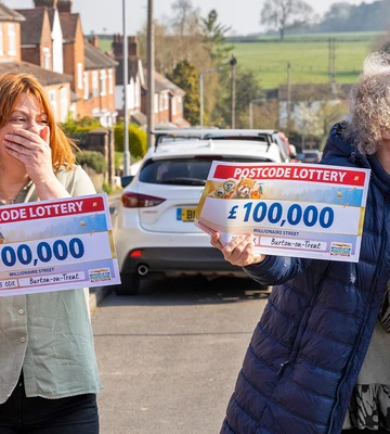 WINNING TOGETHER: Karen gives Jane a kiss on the cheek after a £100k surprise