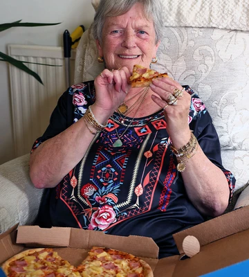 NICE SLICE: Suzanne celebrates by tucking into her favourite ham and pineapple pizza