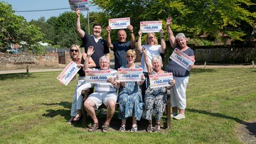 CHEQUE US OUT!: Villagers pose before starting celebrations