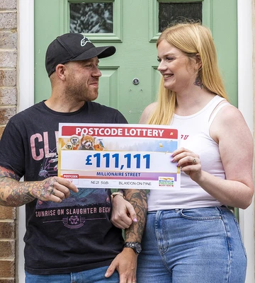 HOUSE ABOUT THAT! Christina and hubby Matthew outside winning address