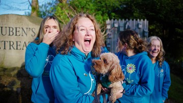 REUBEN'S TREAT: Nicola with therapy-dog-in-training Dolly and staff