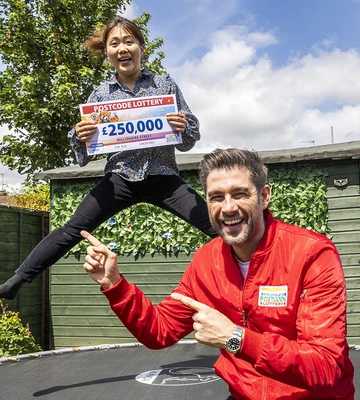 BOUNCING CHEQUE: Winner Yu is jumping for joy after picking up a £250,000 prize