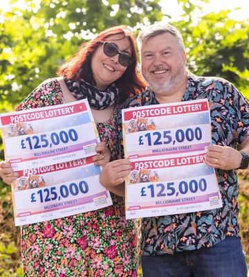 LIFE-CHANGING: £500,000 winner Mark and wife Billie pose with his winning cheques