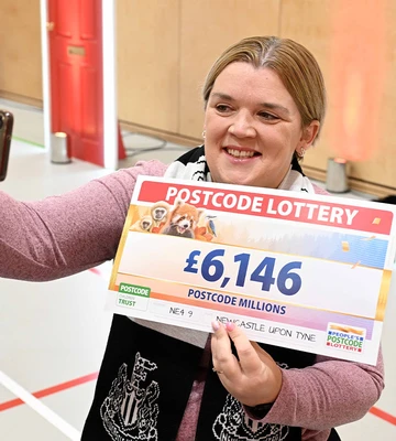 SELFIE CHEQUE: Zoe Dodds poses with cheeses at her windfall