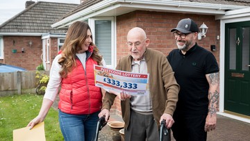 The moment of the reveal - Judie surprises Geoff with a big cheque