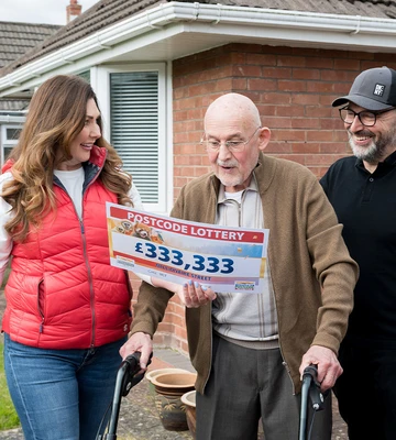 The moment of the reveal - Judie surprises Geoff with a big cheque