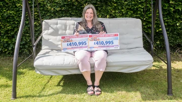 SWING WHEN YOU'RE WINNING: Sally celebrates prize in sun-kissed back garden