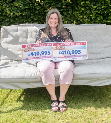 SWING WHEN YOU'RE WINNING: Sally celebrates prize in sun-kissed back garden