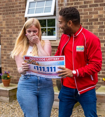 SHOCKED: Christina can't believe amount on cheque presented by presenter Danyl Johnson