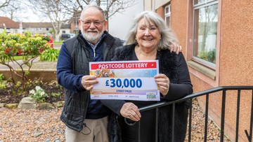 TO HAVE AND TO HOLD: Frances and John clutch her winnings