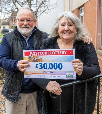 TO HAVE AND TO HOLD: Frances and John clutch her winnings