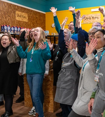 FRUITFUL FUNDING: Staff and volunteers of Community Grocery shop cheer at £75k boost