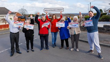 WON HUGELY IN RUGELEY: Neighbours celebrate with Lottery's Judie