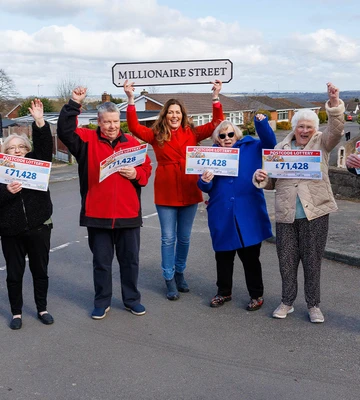 WON HUGELY IN RUGELEY: Neighbours celebrate with Lottery's Judie