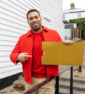 GOLDEN SATURDAY: Postcode Lottery's Danyl Johnson with one of seven winning envelopes