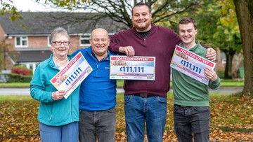 ONES FOR ALL: Gleeful neighbours show off their £111,111 cheques