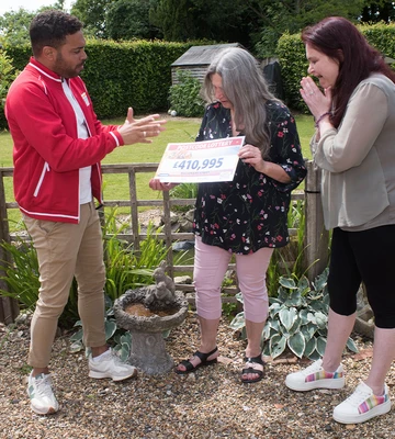 SALLY TALLY: Mum gets first of two cheques from Presenter Danyl Johnson