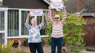 Next door neighbours Olga and Linda hold their winning cheques aloft