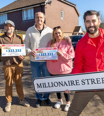 MILLIONAIRE TREAT: Winning neighbours celebrate with lottery's Matt