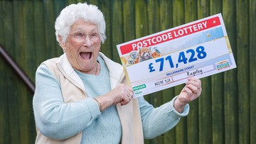GRIN THE MONEY: Happy Janet shows off her winnings