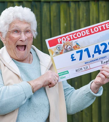 GRIN THE MONEY: Happy Janet shows off her winnings