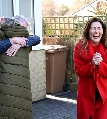 CUDDLE UP: Lesley and Robin fall into each other's arms with cheque